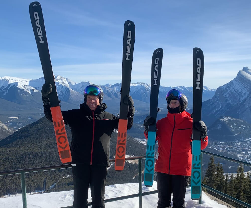 Hali and Greg with skis on a mountain summit during the Skadi Tour